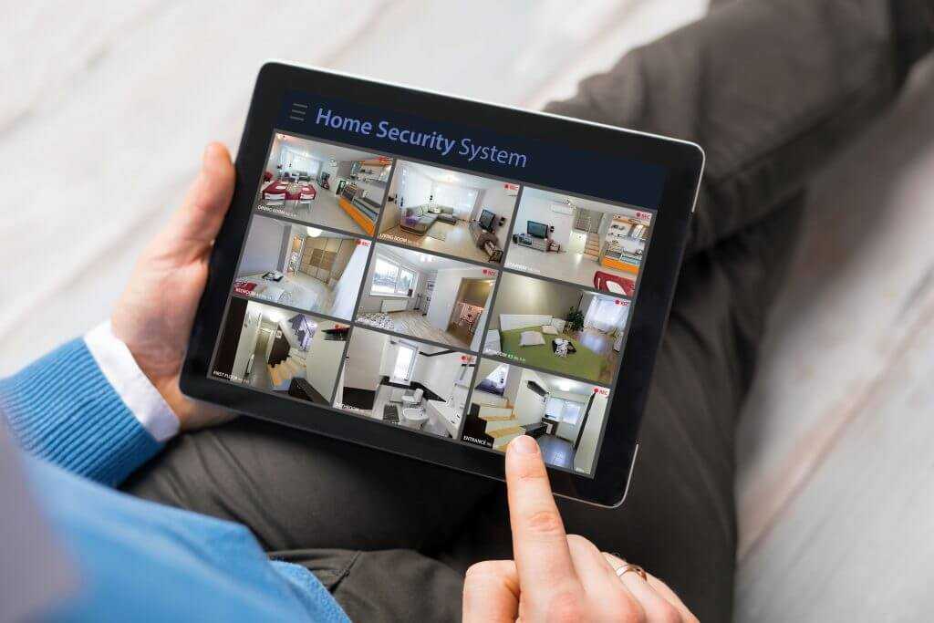 man using home security app to control home system