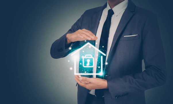 Man in a suit holding a digital icon of a secure house