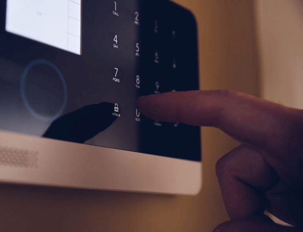 A finger touching a control panel