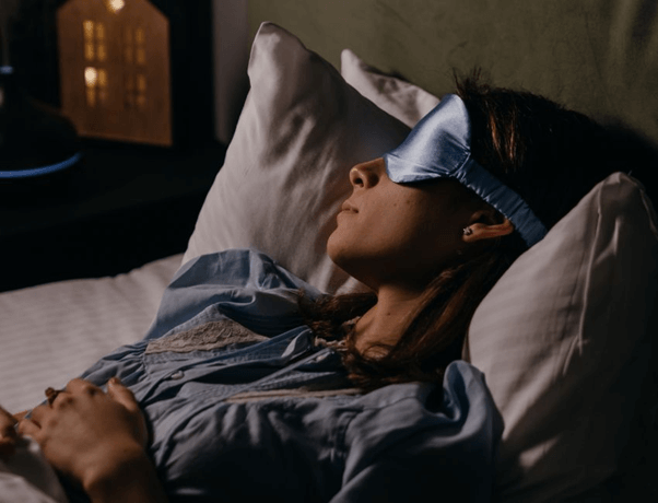 A woman sleeping with an eyemask on
